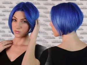 A model with a short bob cut in black and blue, styled with a sleek finish