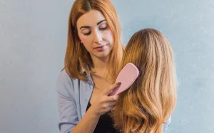 Detangling a short wig with a wide-tooth comb