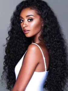 A model with a round face wearing a long curly lace wig with side-swept bangs