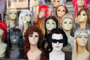 A neat display of multiple wigs on different types of mannequins